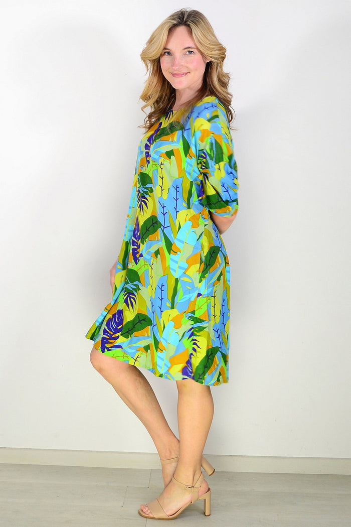 One Summer Charlotte shift tunic dress displayed on a hanger, showcasing a casual, stylish sleeveless design in soft fabric.