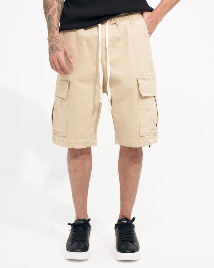 Martin Valen beige oversized gabardine cargo shorts, front mid-thigh view, elastic waist with white drawstring