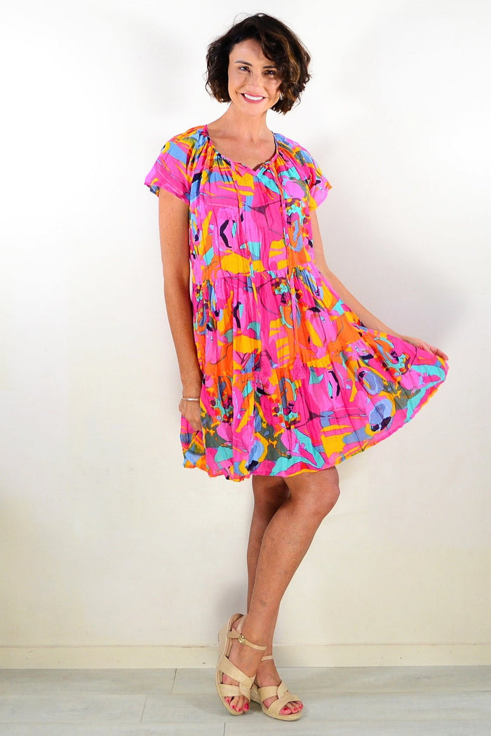 Poppy cap sleeve tassel dress by One Summer, lightweight tunic with tassel details, displayed on a hanger.