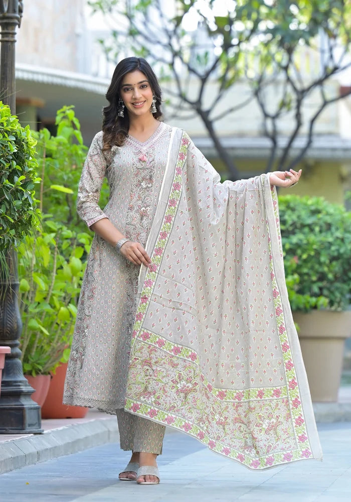 Woman in traditional outfit with floral dupatta standing outdoors