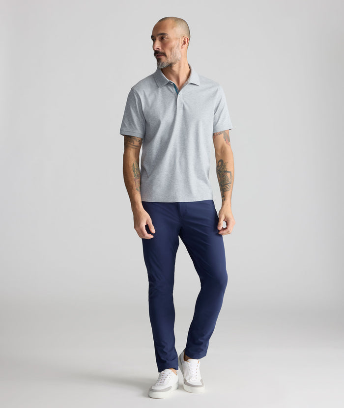Model is wearing UNTUCKit 5-Pocket Performance Tech Pants in Navy.