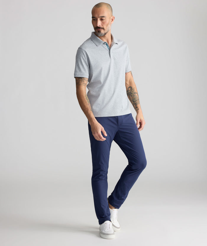 Model is wearing UNTUCKit 5-Pocket Performance Tech Pants in Navy.