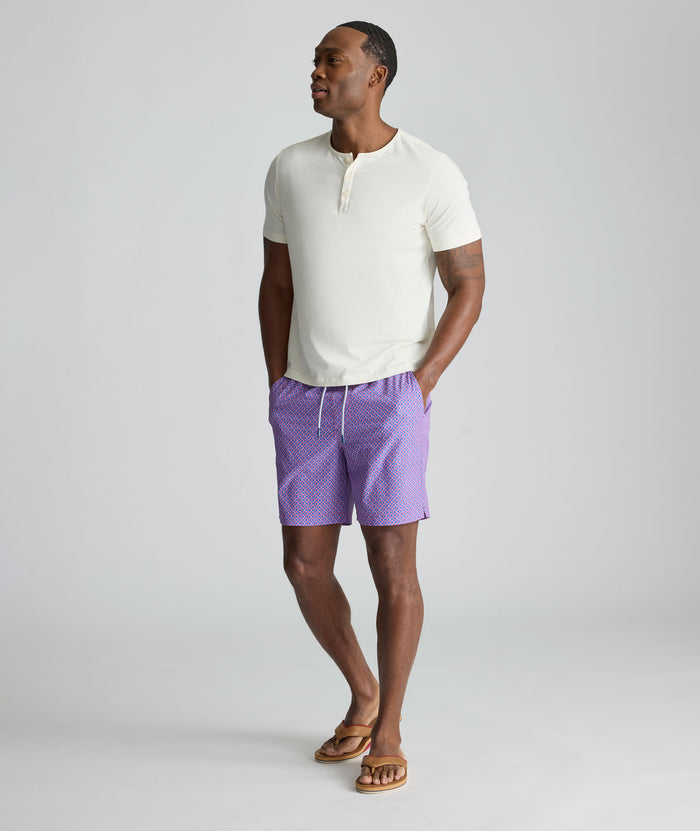 Model is wearing UNTUCKit Beyond Shorts in red and blue.