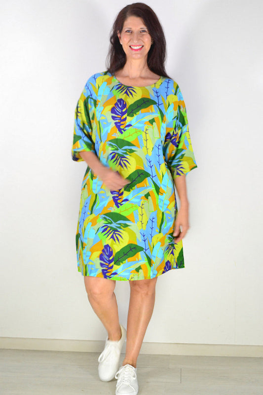 One Summer Charlotte shift tunic dress hanging on a hanger, showcasing lightweight fabric and simple, elegant design.