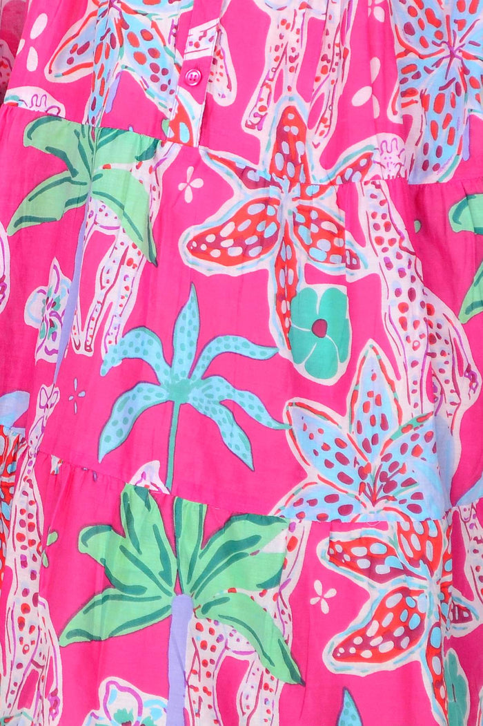 Colorful pink Beth tunic dress by One Summer, featuring vibrant patterns and a relaxed fit, displayed on a hanger.