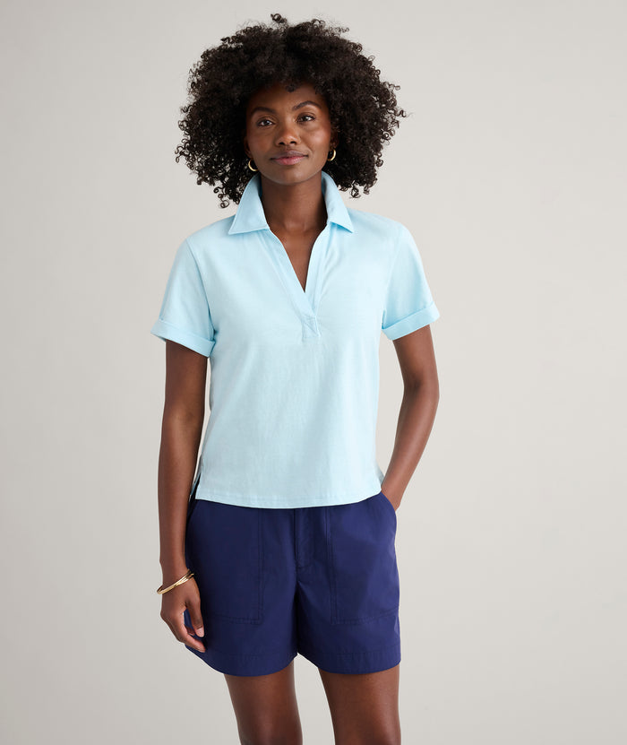 Model is wearing UNTUCKit Cotton Knit Shelby Polo in Solid Aqua Blue.