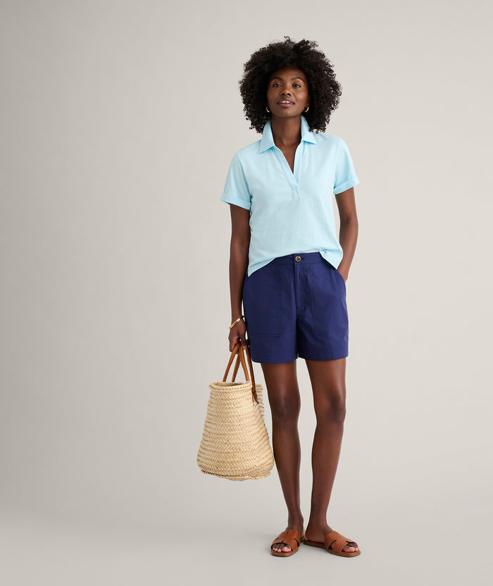 Model is wearing UNTUCKit Cotton Knit Shelby Polo in Solid Aqua Blue.