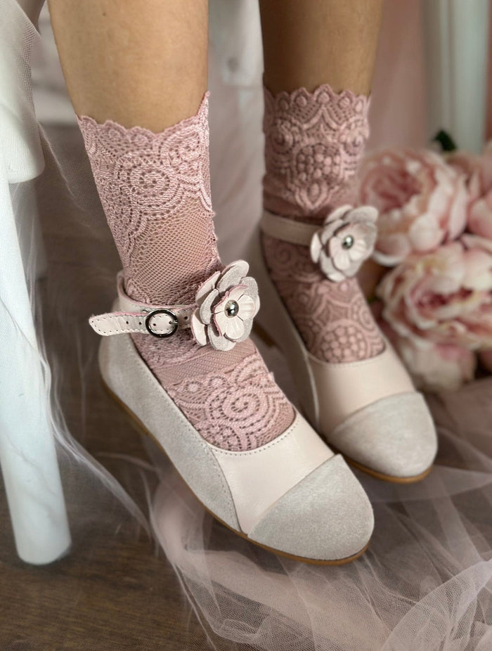 Close up of Faina pink leather Mary Janes featuring layered floral ankle strap and suede toe cap, styled with pink lace socks