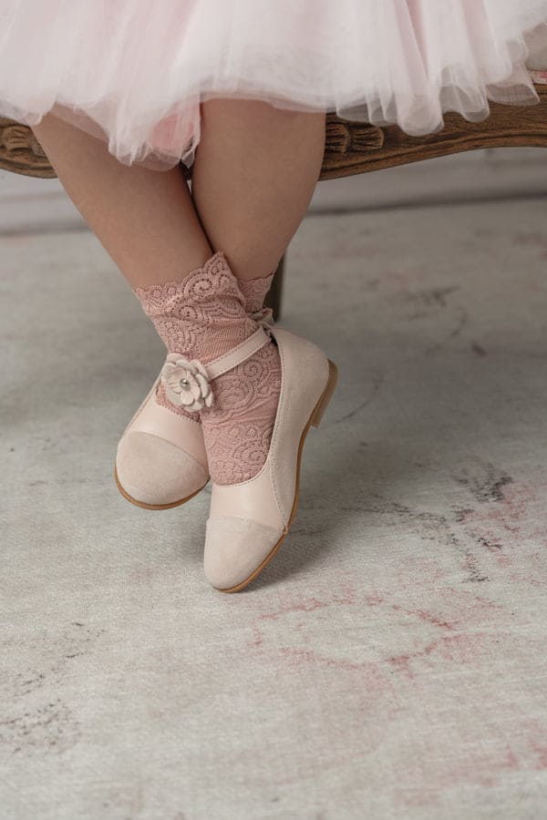 Faina pink leather Mary Janes displayed on soft fabric backdrop girls formal shoes with floral ankle strap and suede toe detail