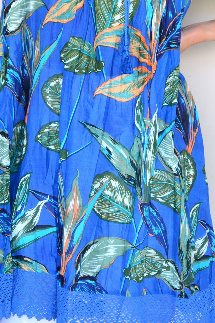 One Summer Hannah Boho Blue Tunic Dress with flowing fabric and bohemian style, displayed on a hanger against a neutral background.