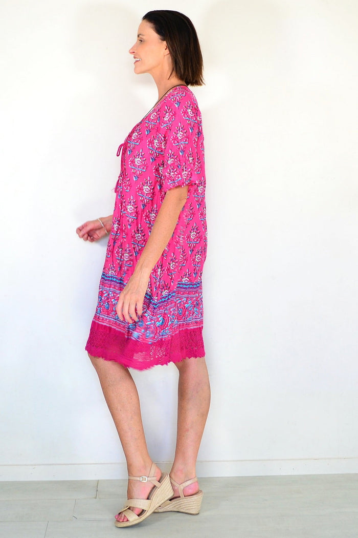 One Summer Hannah Boho short sleeve tunic with a relaxed fit, lightweight fabric, and bohemian style, shown on a hanger.