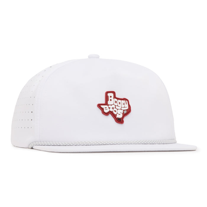 A white snapback hat features a red outline of Texas with the words Boggy Bros in white and red on the front panel. The cap has small ventilation holes on the side and a white rope detail above the brim.