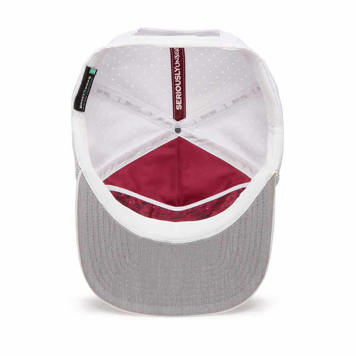 Here’s a rewritten version using your product data: An inside look at the Hard Corps Unstructured Flat Bill Hat – Snapback reveals white side panels, maroon inner panels, a grey underbill with visible stitching, and a white sweatband with dotted lining. A black "Serious Living" label is stitched near the back. Crafted from high-performance material, the cap’s interior construction and seams are clearly visible.