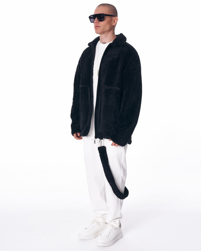 Martin Valen men's black plush cardigan, three-quarter view with raised collar and front patch pockets