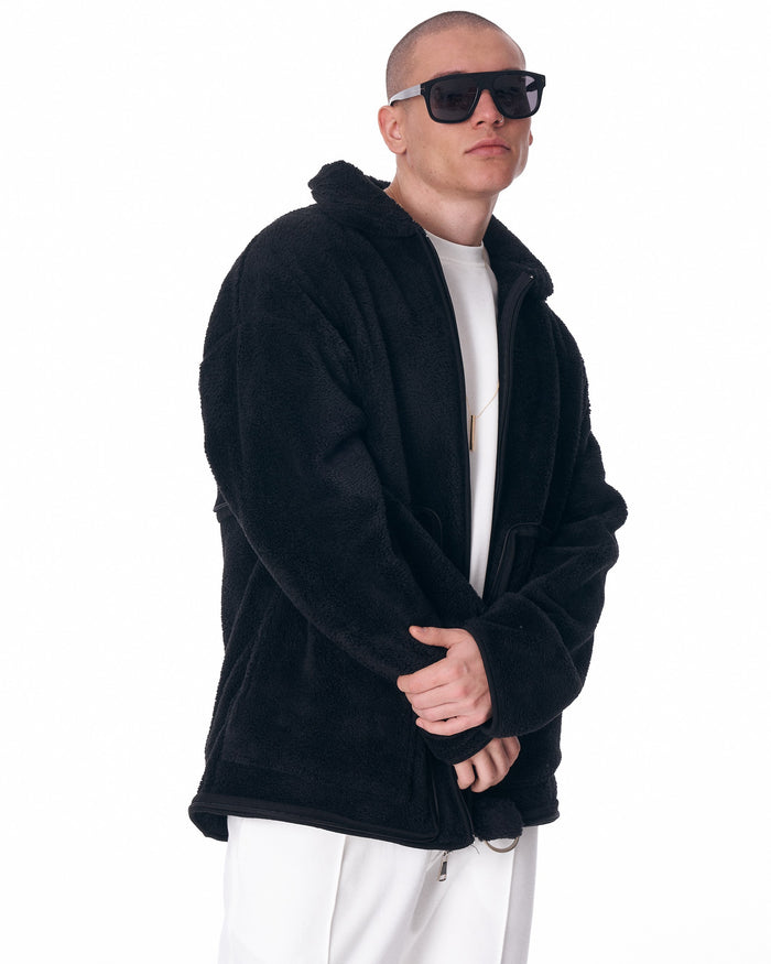 Martin Valen men's black plush cardigan, three-quarter torso view with hood and partially closed zipper