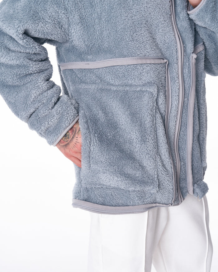 Martin Valen gray plush cardigan close-up, front patch pocket with trim and visible zip, soft fleece texture shown
