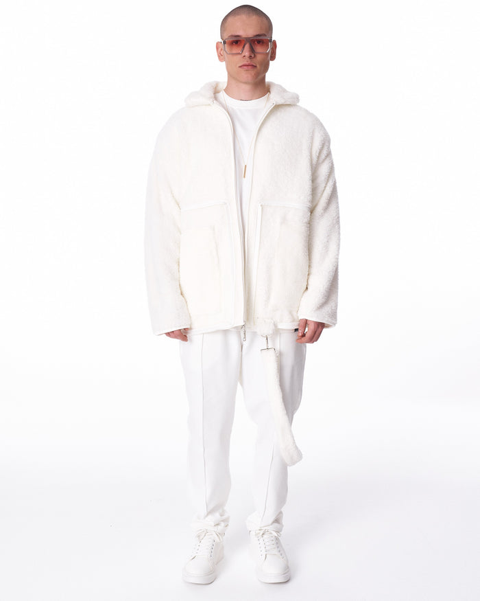 Martin Valen white plush cardigan full-body front view, showing hood, zipper and long plush strap accessory