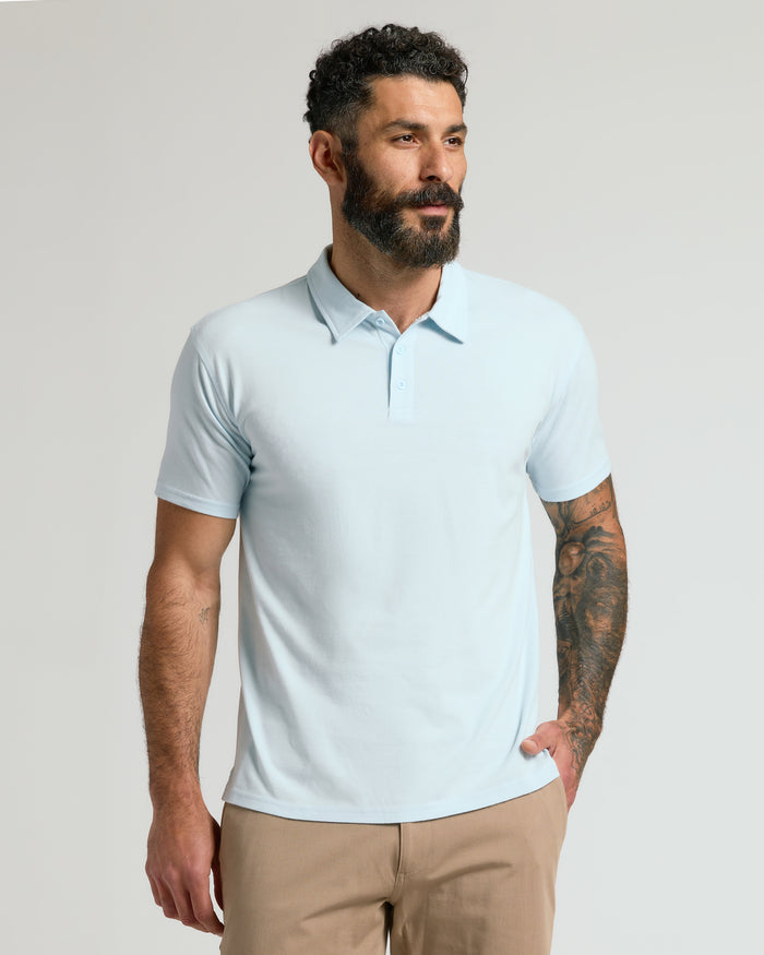 Man wearing Icicle Classic Polo with tattooed arm, looking right.