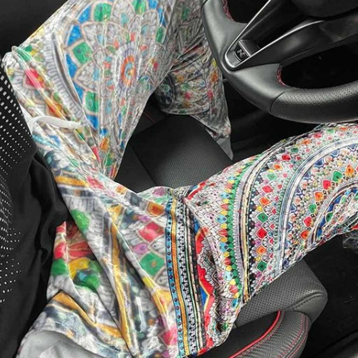 These joggers showcase a kaleidoscopic mandala pattern radiating in concentric layers across shimmering silver fabric with a crushed velvet sheen. Contact us with accessibility feedback, we'd love to help!