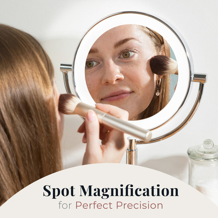 Zadro LEDVR310 705004421737 environment photo front view on makeup table with user applying blush on cheek, laguna lighted makeup mirror with magnification in front of a real life setting