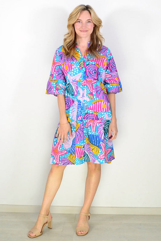 Maya Button V Neck Layer Tunic Dress by One Summer, featuring a flowing layered design and button details, worn casually.