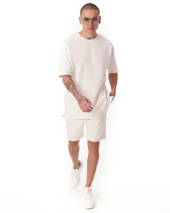 Martin Valen men's oversized white shortsuit, front mid-body view showing light fabric and short sleeves