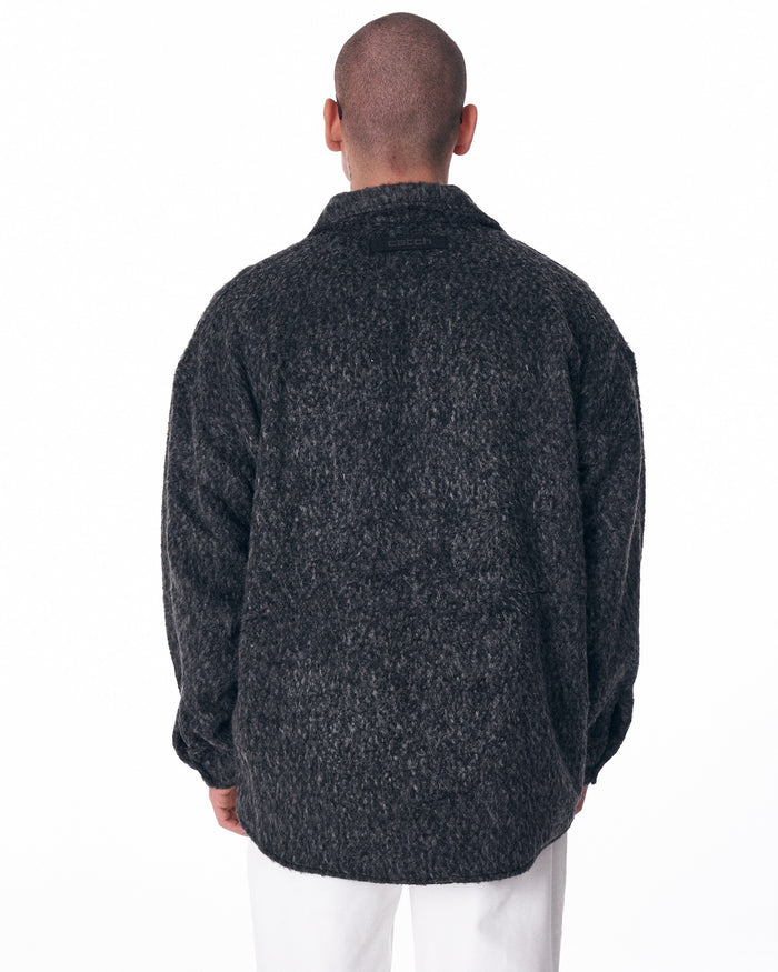 Martin Valen men's button-down wool cardigan in dark grey, mid-body front view showing fuzzy wool texture, long sleeves and rounded hem