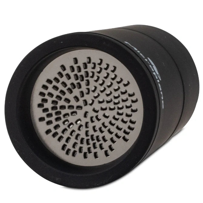 Black cylindrical Microplane spice grater bottom blades on white background.