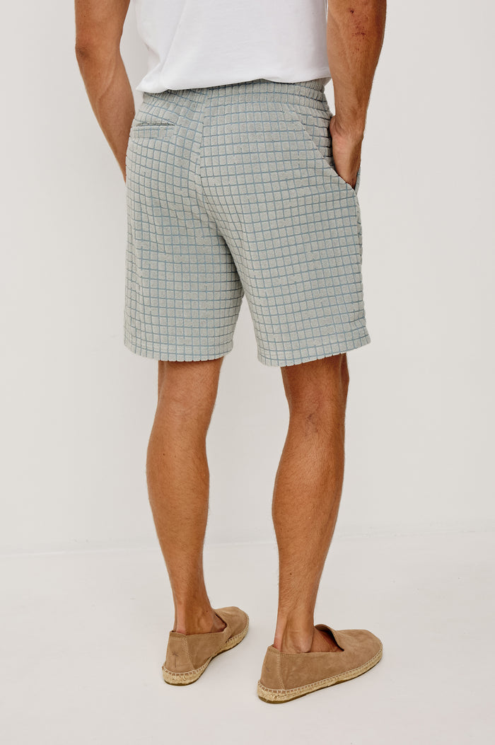 Nova Short in French Terry With Raised Jacquard Pattern, Side Pockets, and Drawstring Waist Ties in Silver Line Grid Colorway - Lower Body Back View Featured on Model