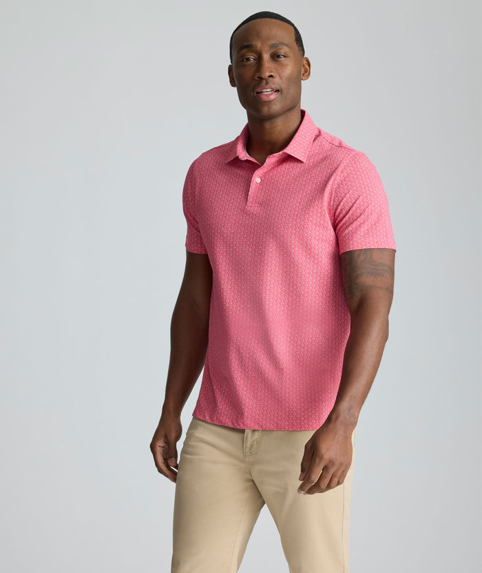 Model is wearing UNTUCKit Model is wearing UNTUCKit CottonTek Polo in Magenta Wine Bottle Print.