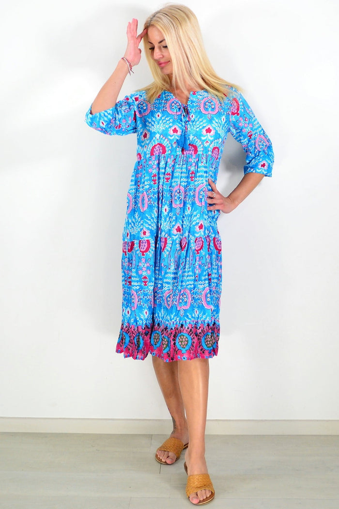 Rebecca Blue Tie Neck Midi Dress Tunic by One Summer, showing a stylish blue dress with a tie neck and midi length, displayed on a hanger.