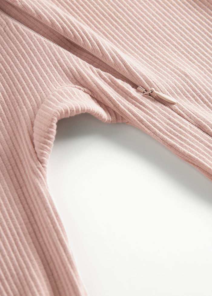 Ribbed pink baby jumpsuit in soft material with long sleeves and long legs and zipper