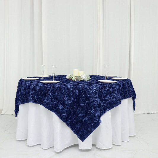 Navy rose-patterned tablecloth on a round table with plates and candles