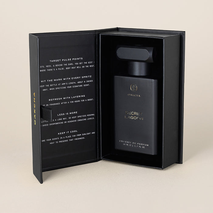 Front view of 50 ml Secret Lagoon perfume bottle in black presentation box with printed notes on the inner lid