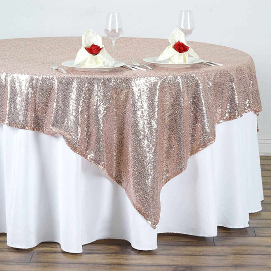 Rose gold sequin tablecloth draped elegantly over a white table.