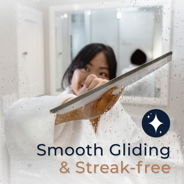 Zadro ZSQ10B2C 705004424622 environment photo front view user gliding across shower door with features, smooth gliding squeegee blade in front of a real life setting