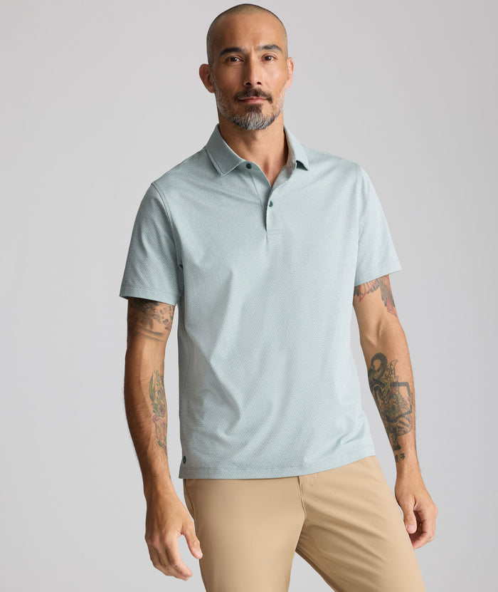 Model is wearing UNTUCKit Textured Performance Polo in green.