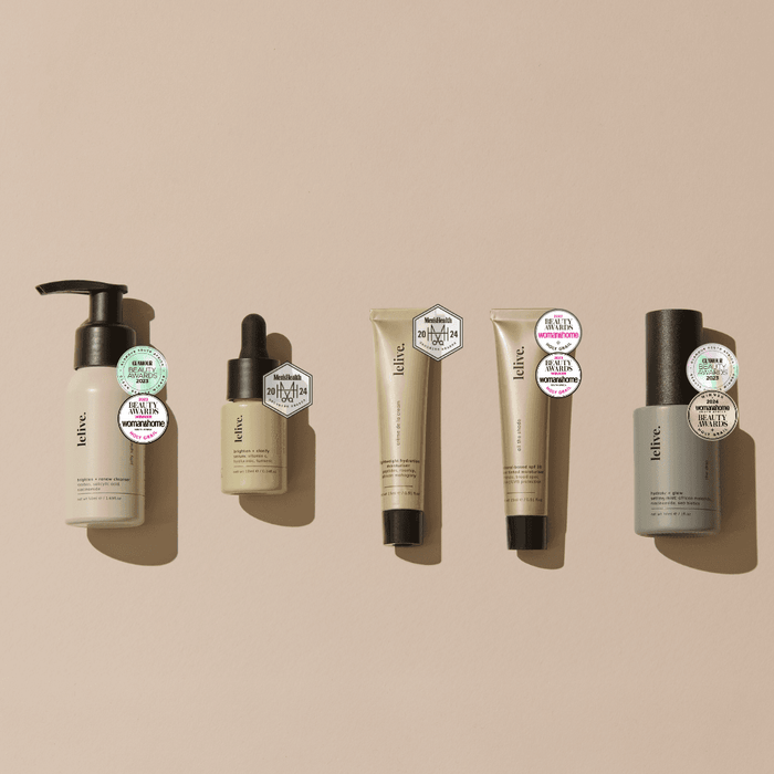 A collection of five mini skincare products from the brand Lelive, including a cleanser, brightening serum, moisturizer, tinted spf and a setting mist, each in travel-sized packaging.