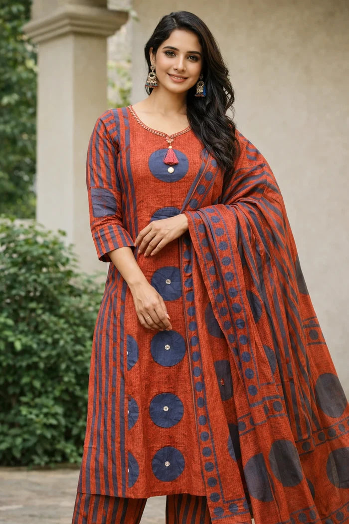 Woman wearing a traditional red and blue outfit with a matching dupatta.