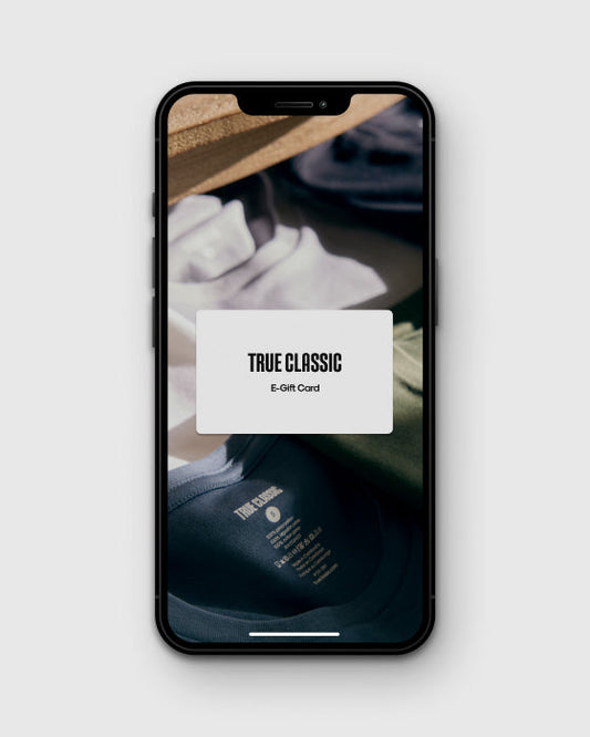 Gift Card Product Test displayed on smartphone with folded T-shirts.