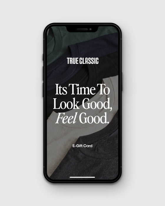 TRUE CLASSIC Gift Card Product Test on smartphone with T-shirt stack.