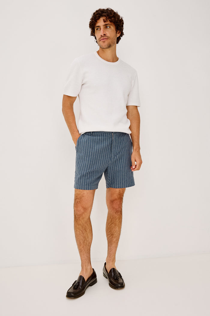 Wilson Short in Linen With a Straight Fit, Clean Front Waistband, Elasticated Back, Front Zip Fly, and Side Pockets in Navy Multi Stripe Colorway - Full Body Front View Featured on Model