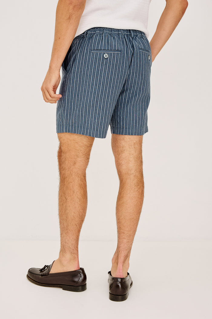 Wilson Short in Linen With a Straight Fit, Clean Front Waistband, Elasticated Back, Front Zip Fly, and Side Pockets in Navy Multi Stripe Colorway - Lower Body Back View Featured on Model