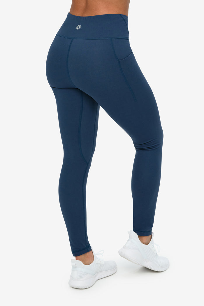 Navy blue leggings worn by a person on a white background