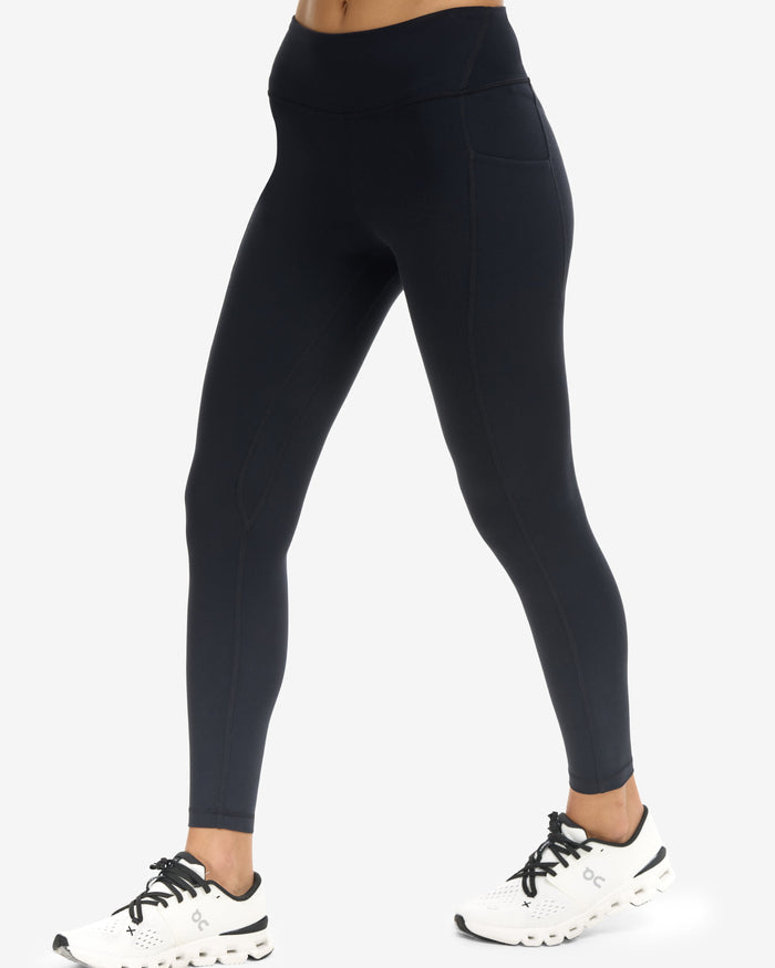 Person wearing black leggings on a white background