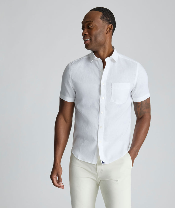 Model wearing an UNTUCKit Bright White Wrinkle-Resistant Linen Short-Sleeve Cameron Shirt.