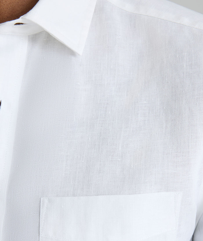Model wearing an UNTUCKit Bright White Wrinkle-Resistant Linen Short-Sleeve Cameron Shirt.